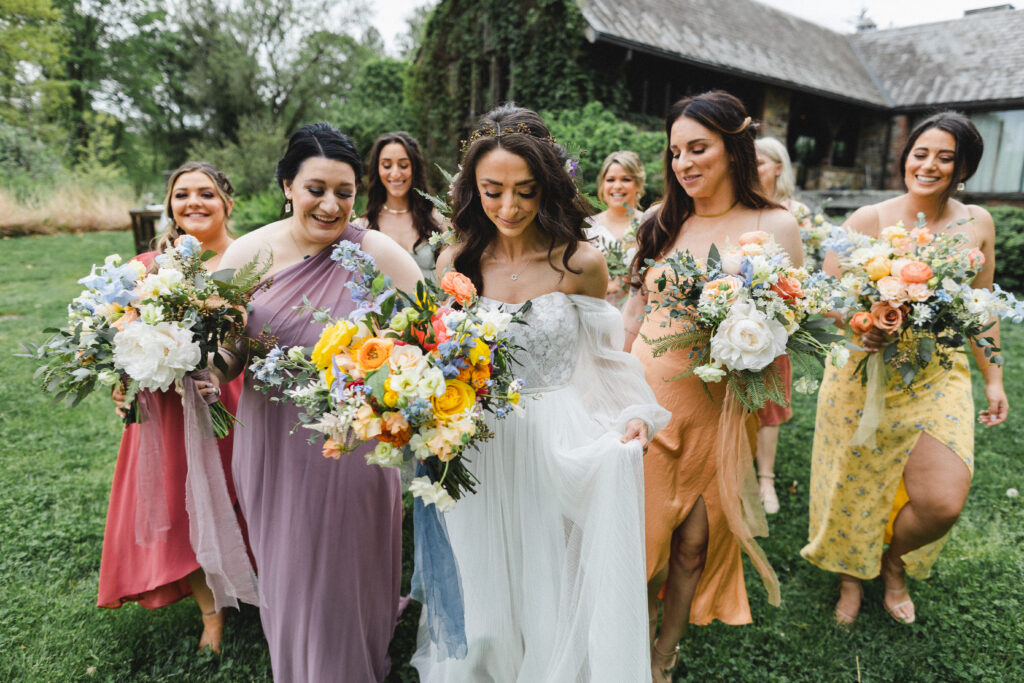 Bride and her bridesmaids with their colorful bouquets for spring wedding at Blue Hill at Stone Barns, Long Island NY Florist