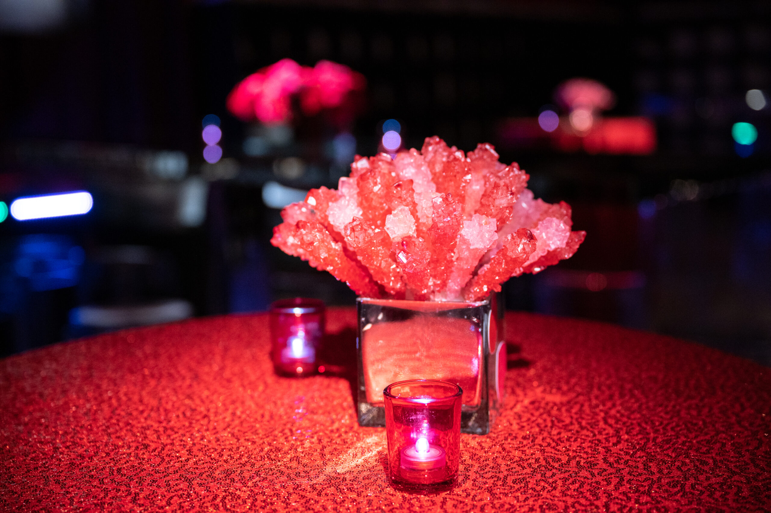 Close up of red themed bat mitzvah's rock candy centerpieces, Long Island NY Florist